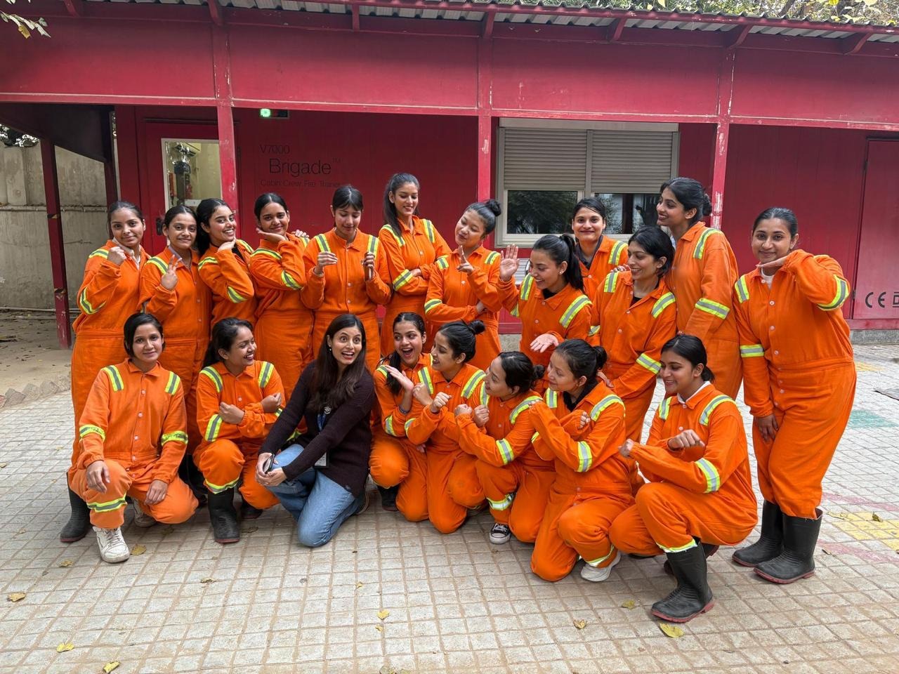 FlyGlam students in fire-retardant coveralls at a cabin crew fire trainer