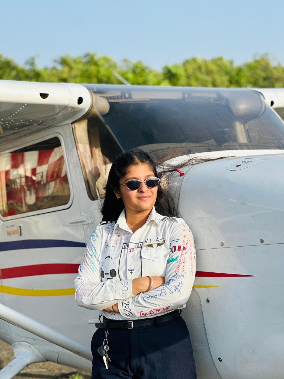 Nitu Rosha, founder of FlyGlam Academy, beside a training aircraft