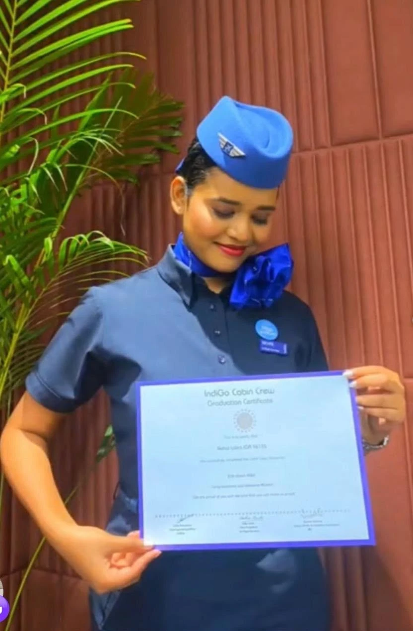 Nehal in her IndiGo cabin crew uniform holding her graduation certificate